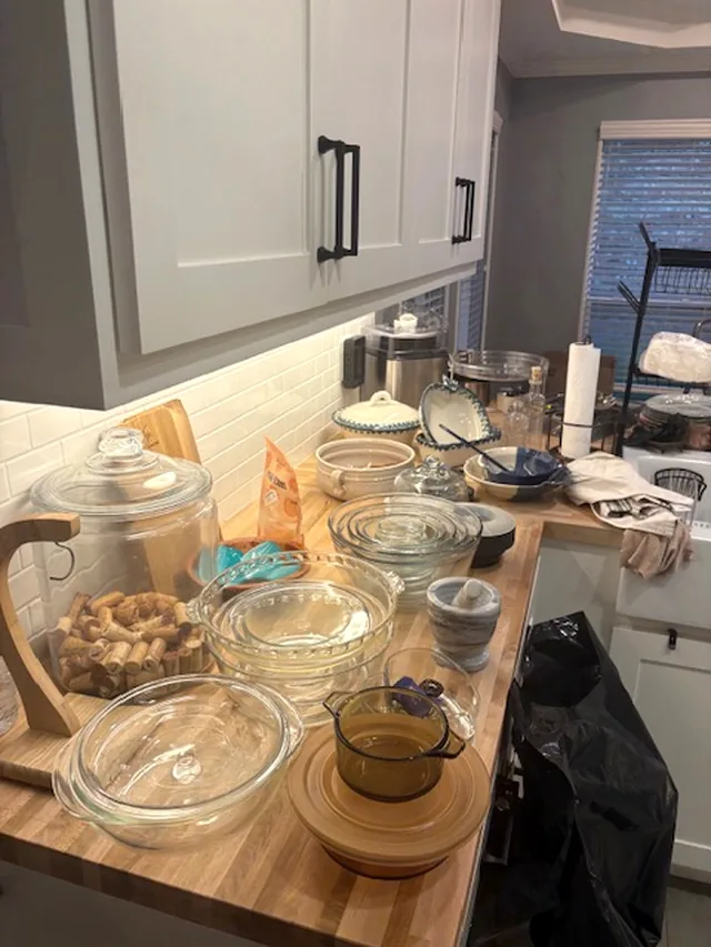 A butcher-block counter covered in glass bakeware