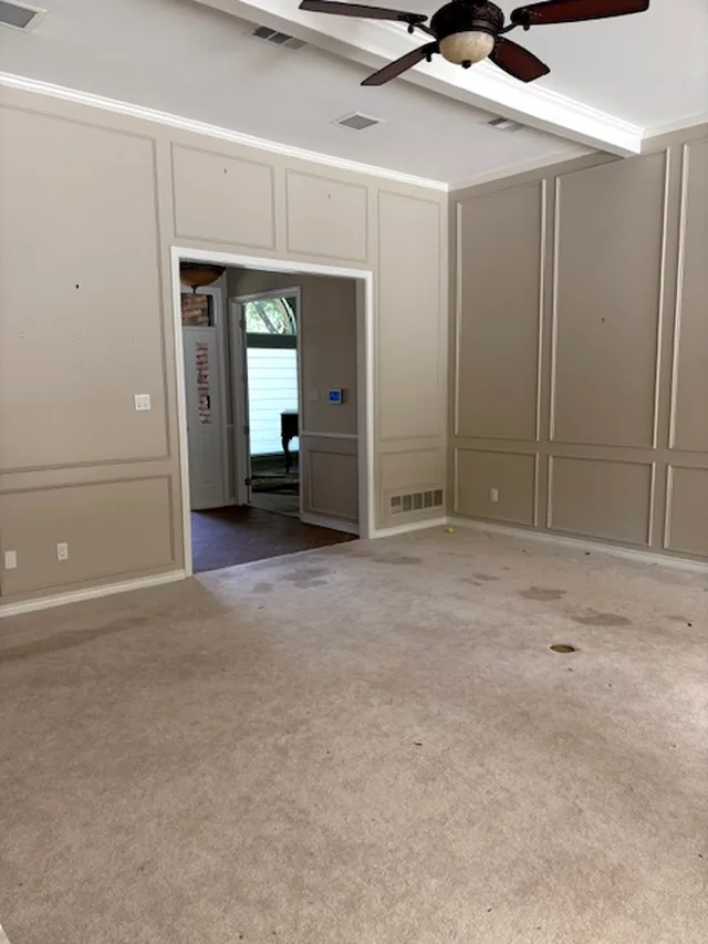 The same living room cleared to the carpet