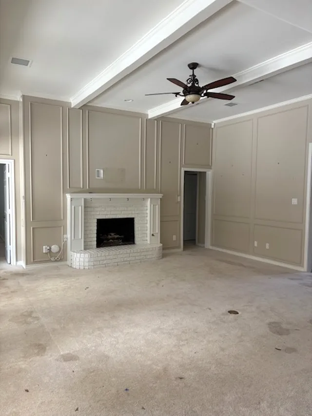 The fireplace wall of the same living room, empty
