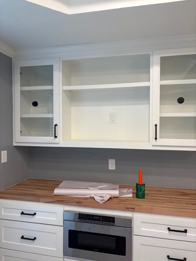 The same counter and glass-front cabinets, empty