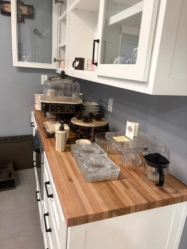 A buffet counter covered in serving pieces and glass trays