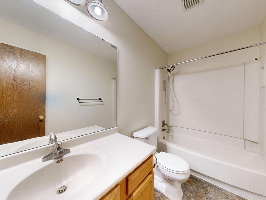 an older bathroom with the original vanity, toilet and tub before a remodel