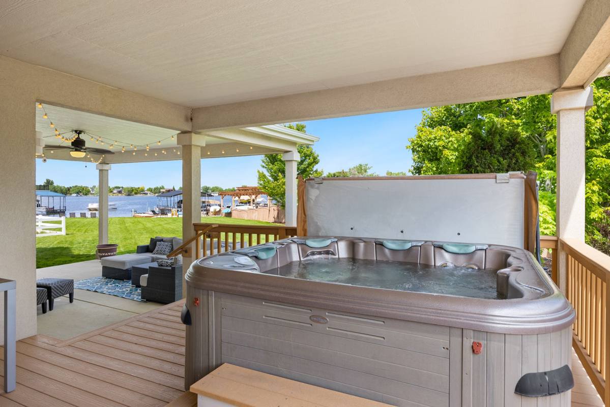 A hot tub on a covered back porch