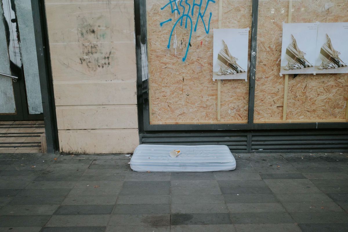A single mattress left out on a sidewalk