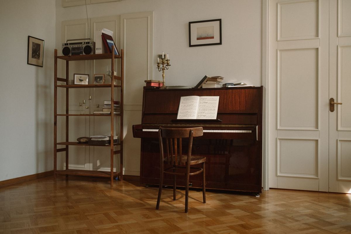 An upright piano against the wall of a home