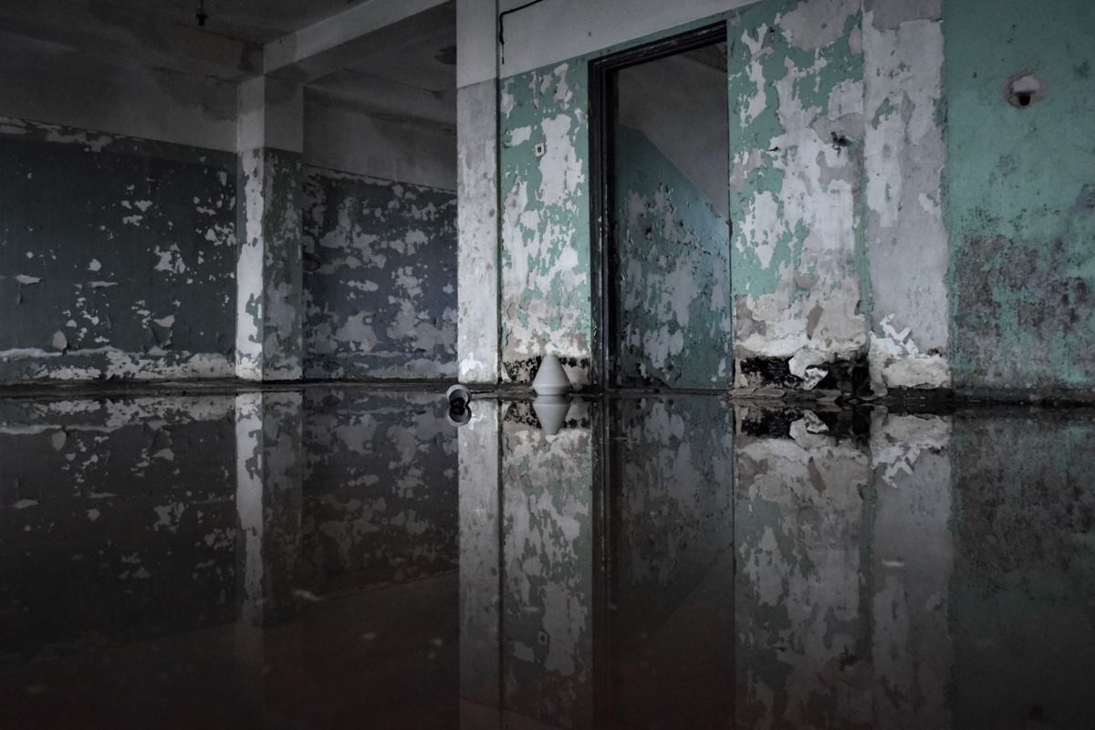 Standing water across the floor of a room after a leak