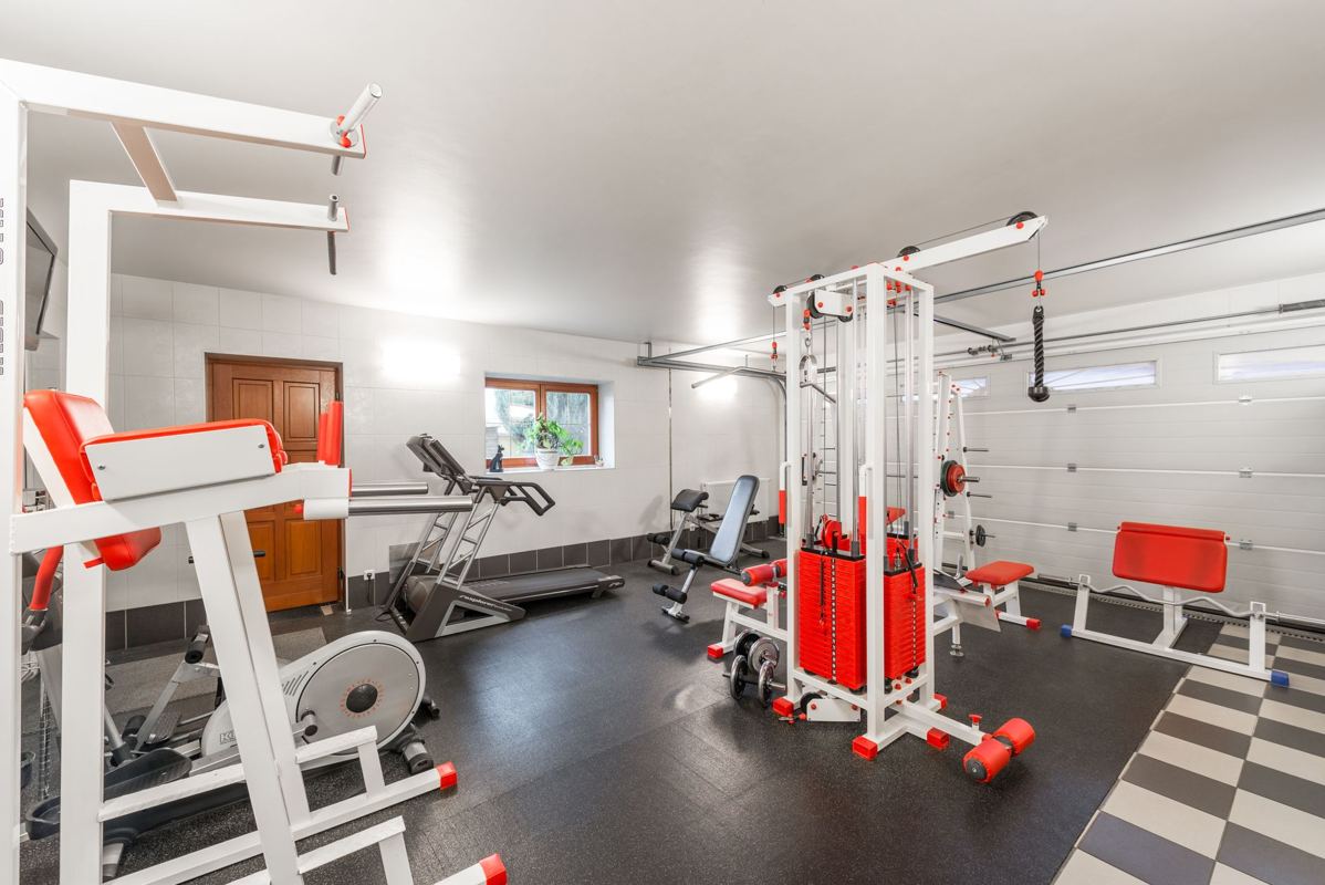 A home gym with a cable machine and an exercise bike
