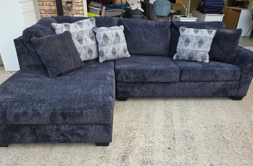 Navy sectional sofa hauled by Hero’s Junk Removal