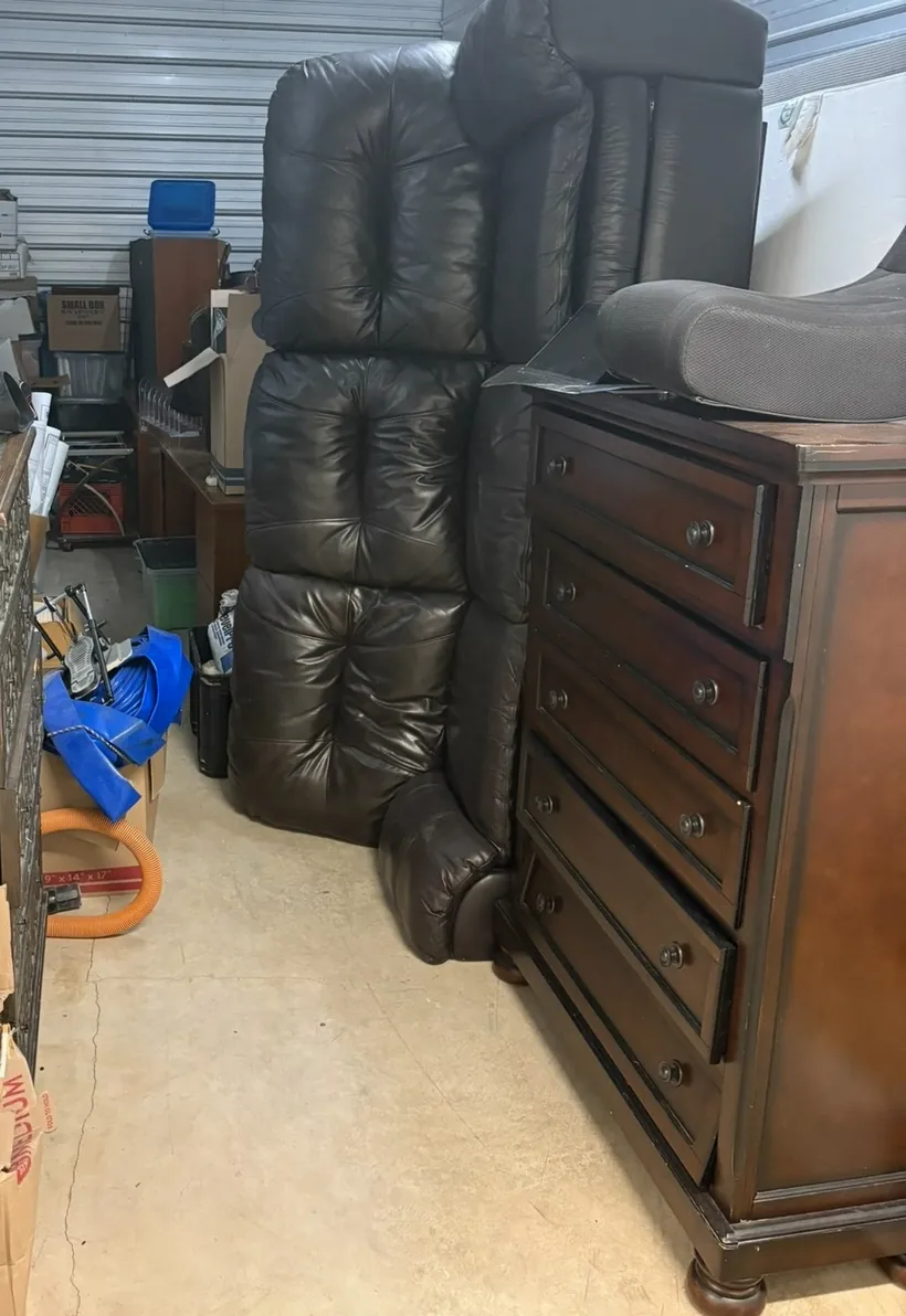 A leather sectional and a wood dresser in a storage unit, ready to go
